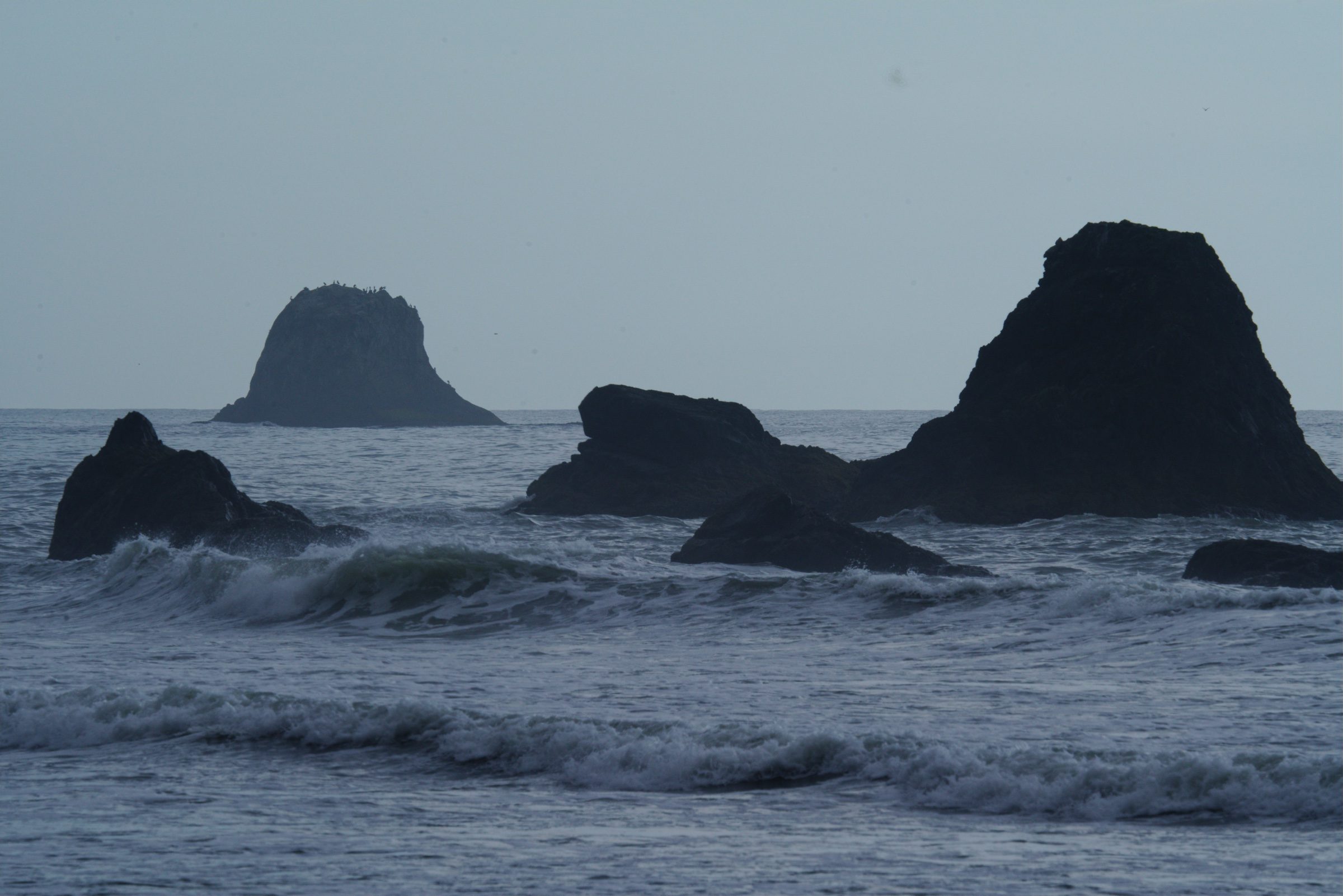Proposed: the same frame with black rock, cold blue water and deeper contrast.